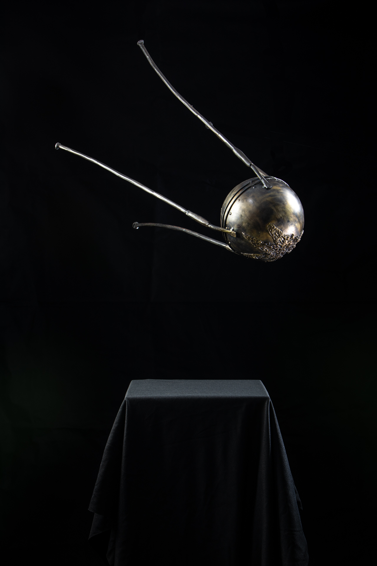 Artistic metal sculpture with spherical body and extending rods, handcrafted wrought iron art piece