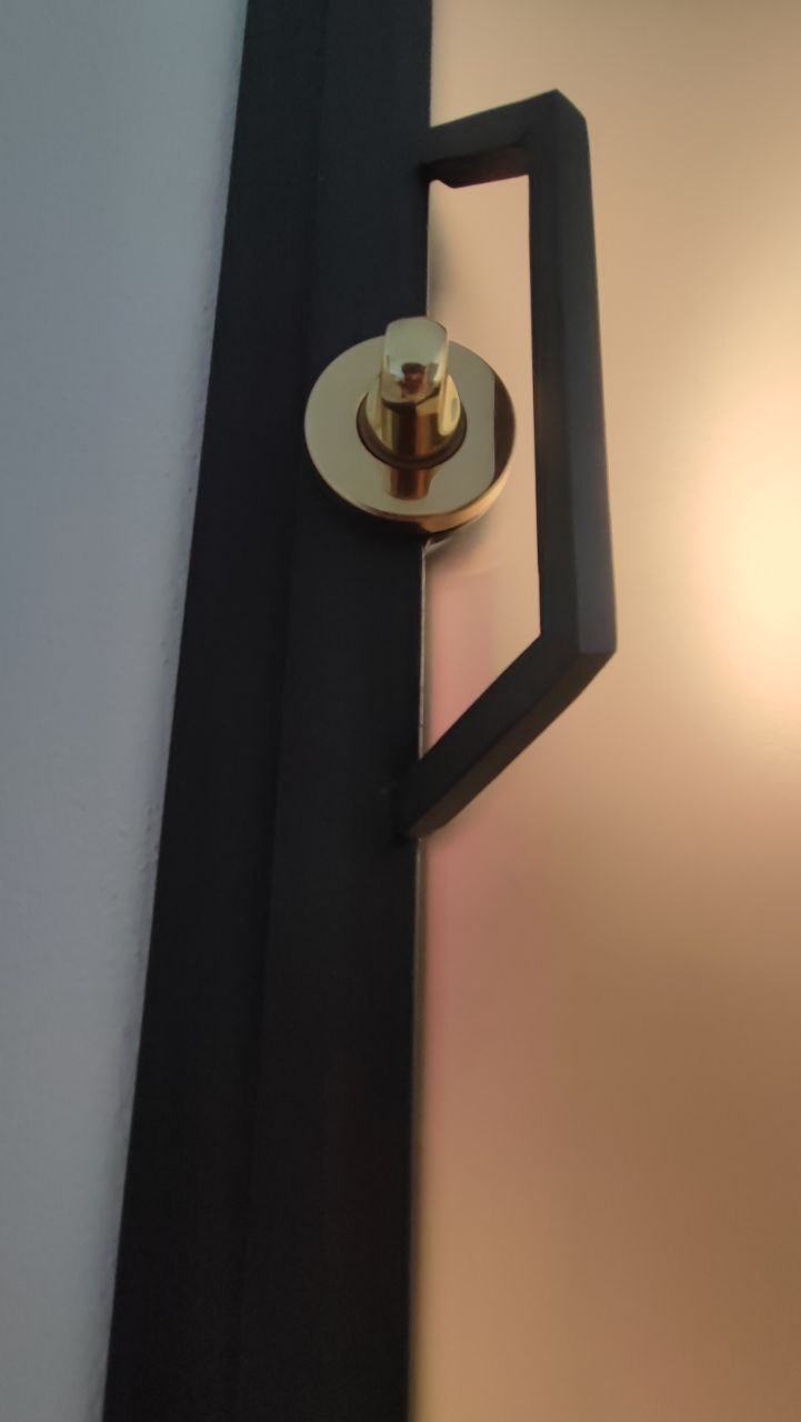 Close-up of golden brass handle on modern interior door