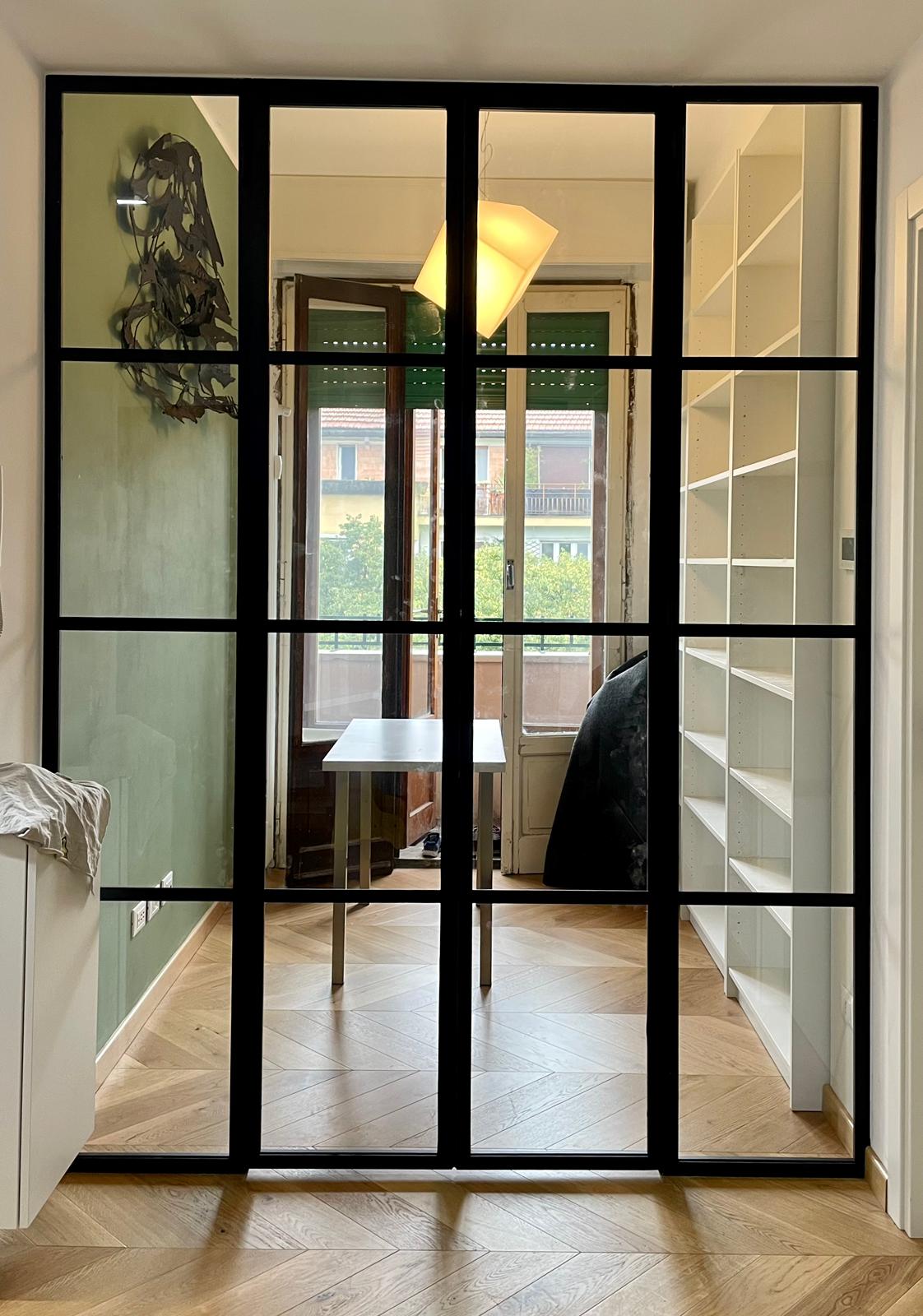 Industrial style glass partition door with black steel grid