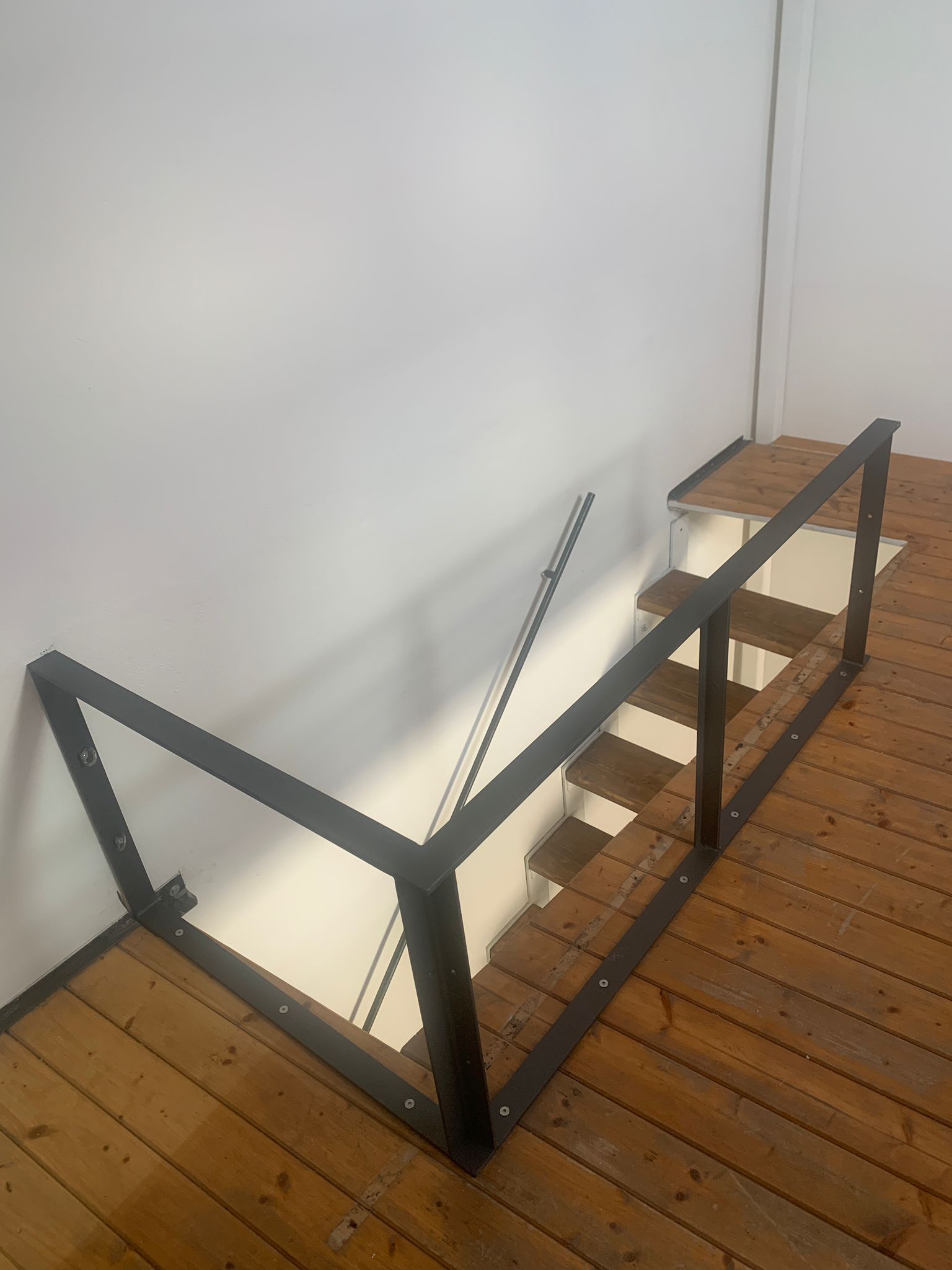 Modern staircase with wood treads and black iron structure