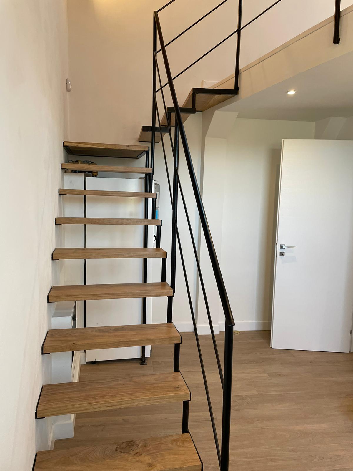 Custom iron staircase with geometric safety railing