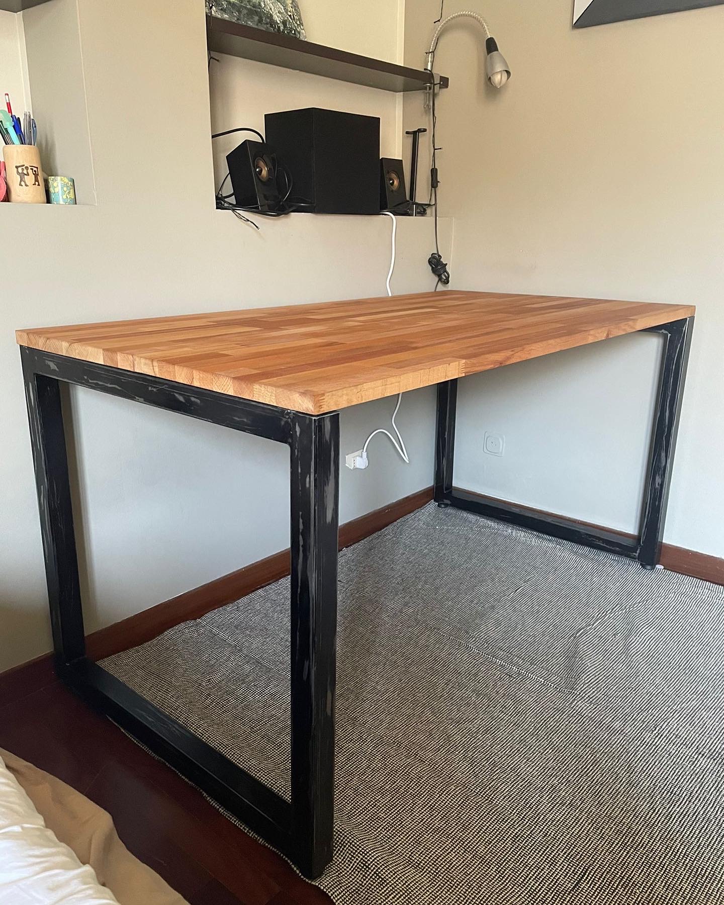 Industrial desk with black metal frame and wooden butcher block top