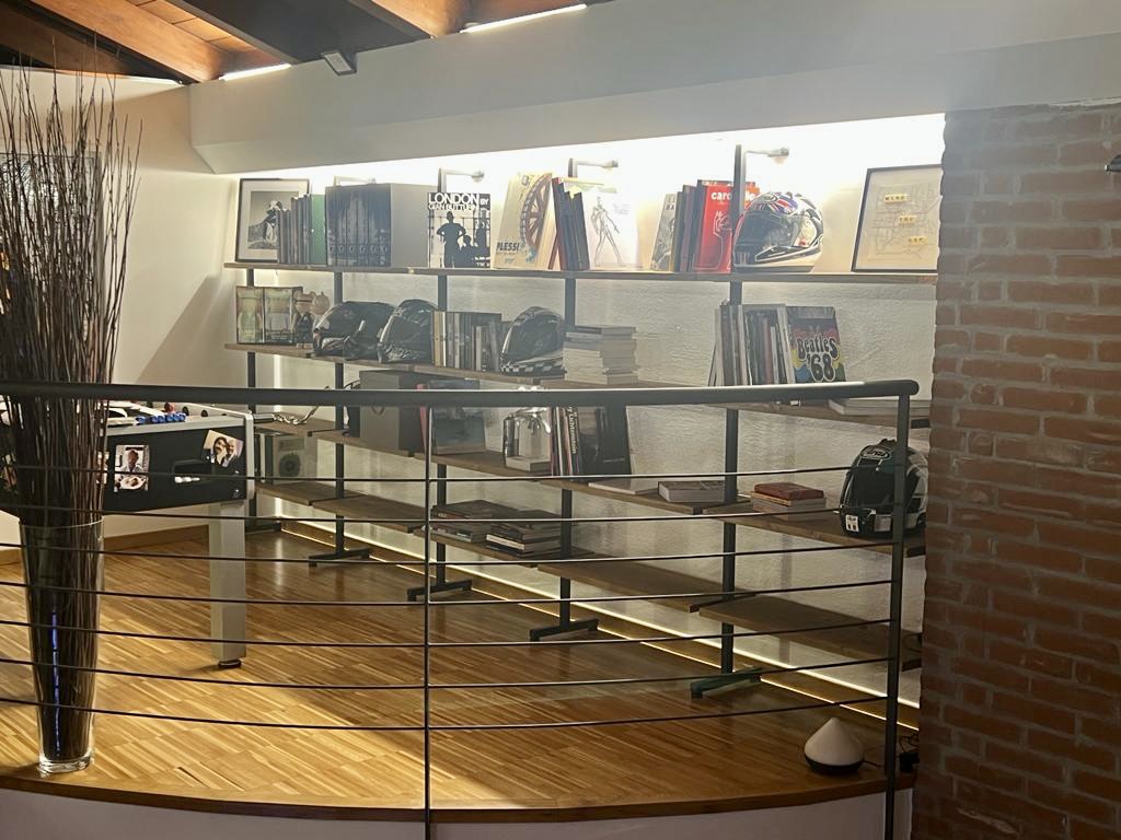 Mezzanine bookshelf with safety railing and multiple shelving levels