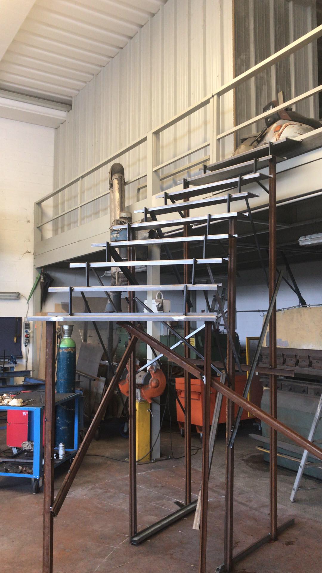 Industrial metal staircase with platform levels for workshop