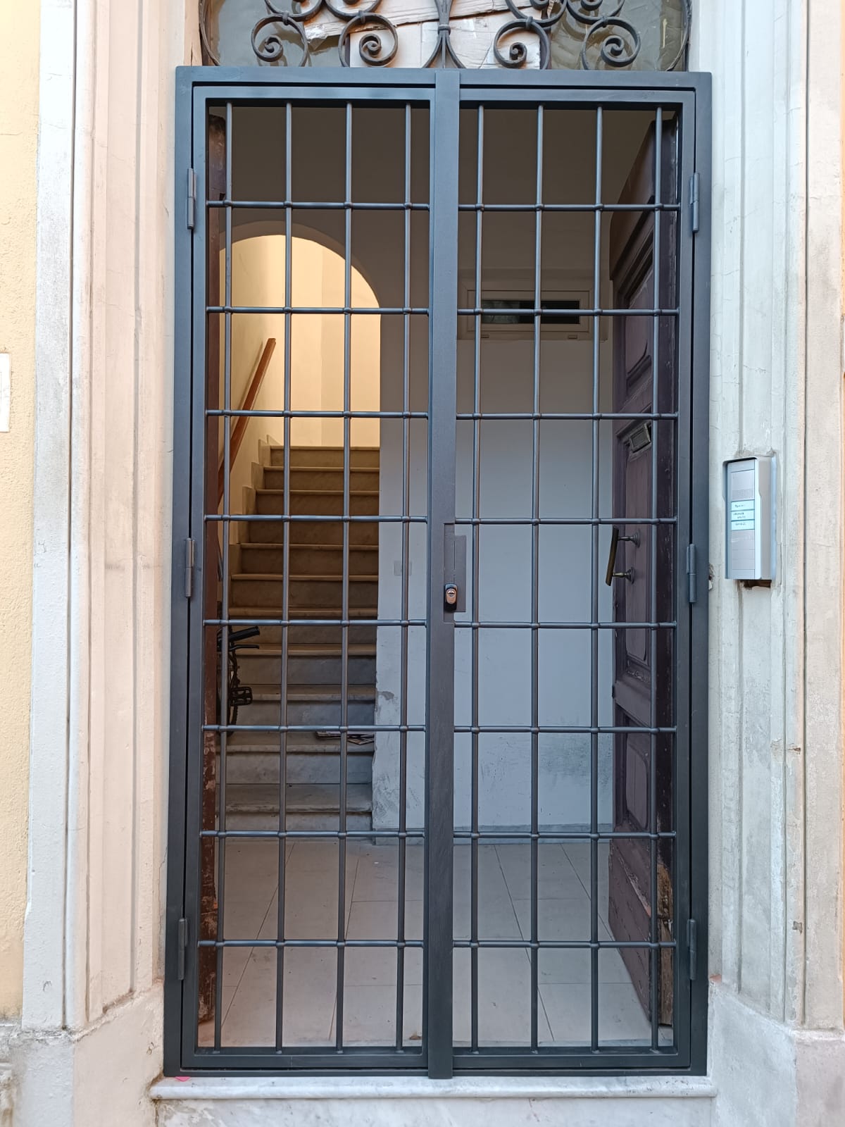 Custom security gate with metal grid pattern, providing both protection and visibility